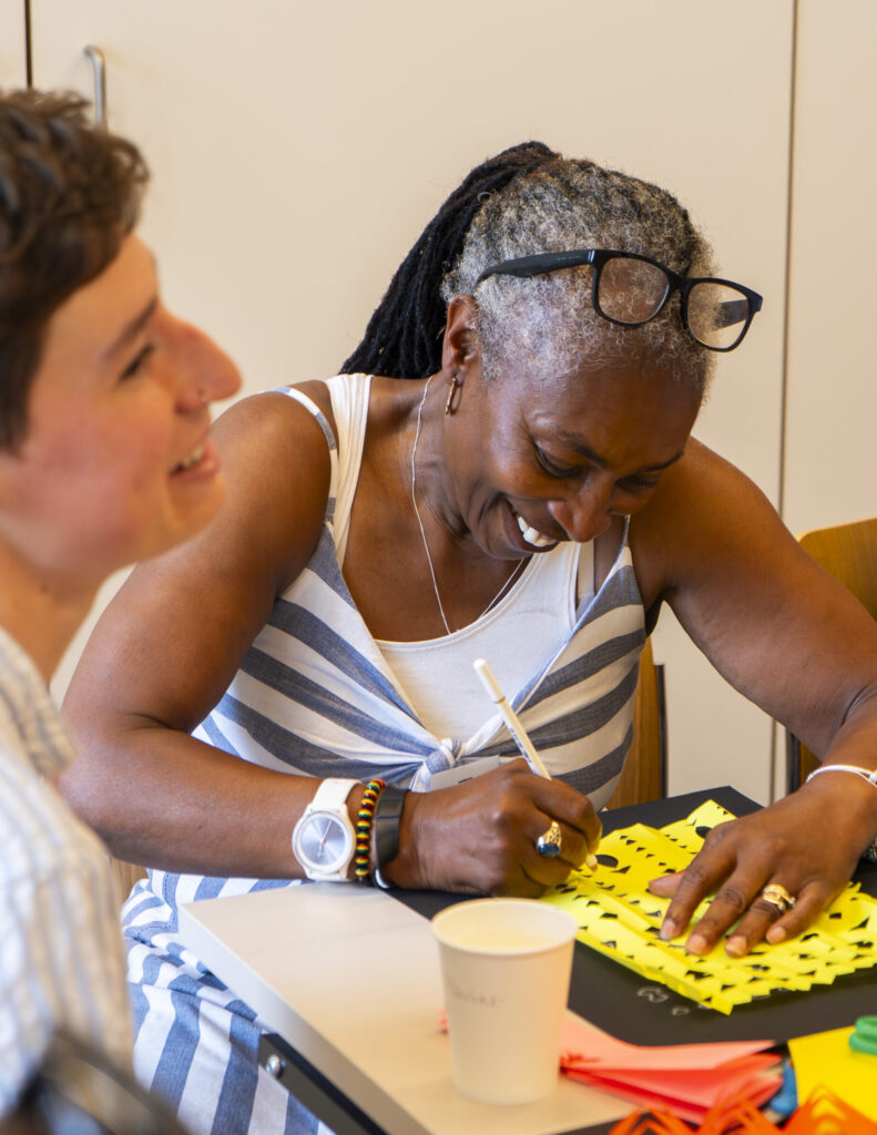 Participants making lace designs with paper