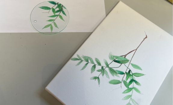 Delicate painting of leaves on canvas and replicated on glass