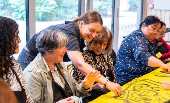 Artist working on collaborative piece with participants