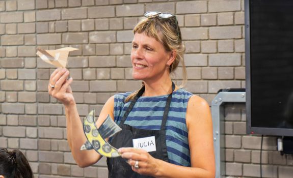 Artist holding participants 3D paper birds