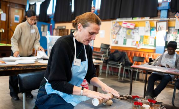 Helen demonstrating rolling clay during a workshop