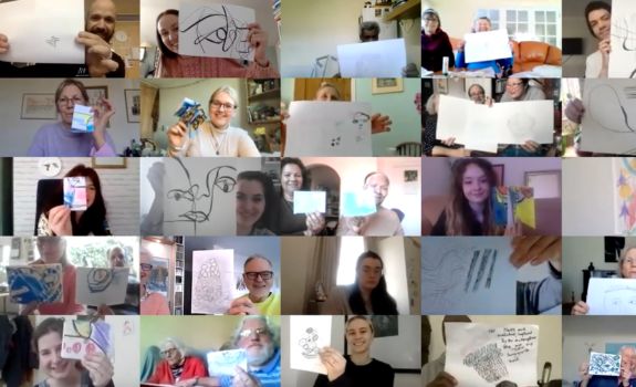 Zoom screen photo of many participants holding up their artworks