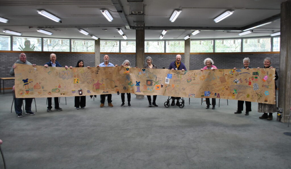 Participants proudly holding the collaborative scroll created during the Park Theatre programme