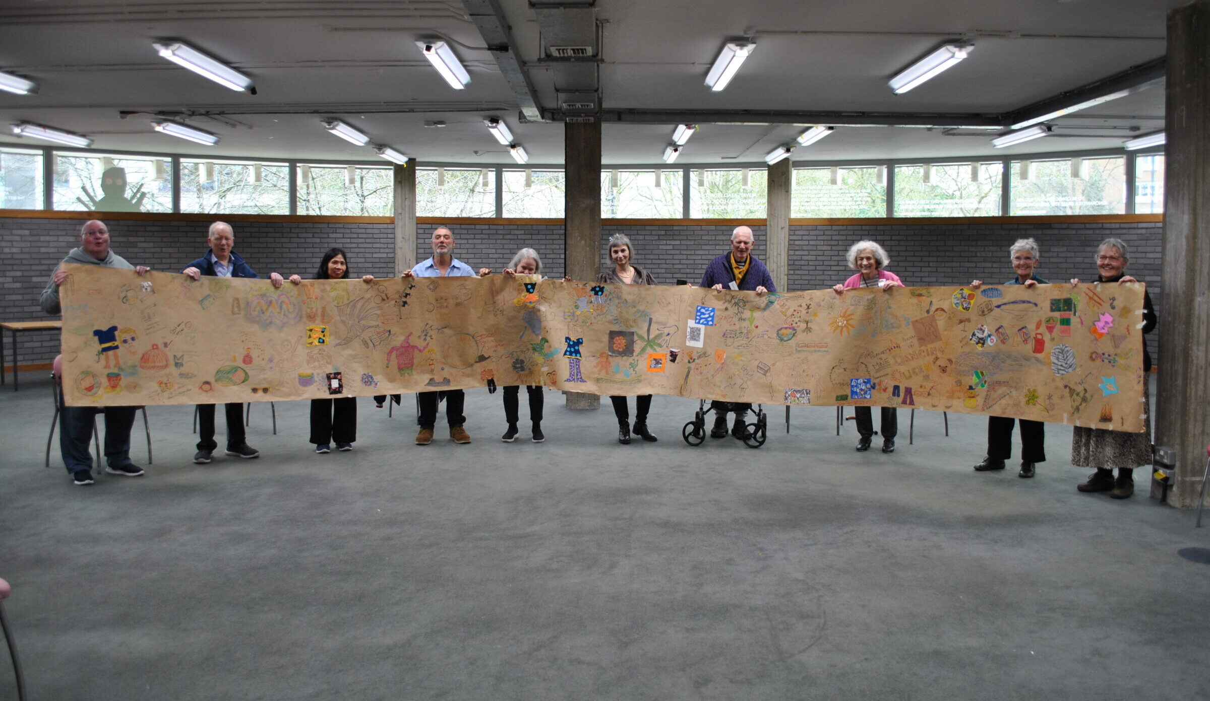 Participants proudly holding the collaborative scroll created during the Park Theatre programme