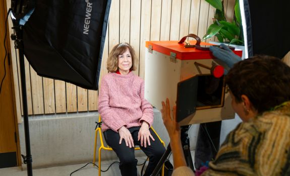 Participant being photographed with a box camera