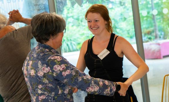 Mathilda dancing with a participant at an English National Ballet workshop