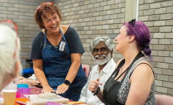 Artist, participant and volunteer all enjoying a laugh during the ceramics workshop