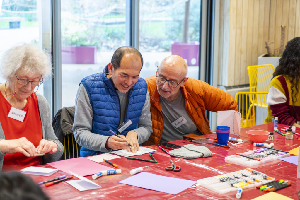 Two participants making card photo frames at the Box Camera workshop