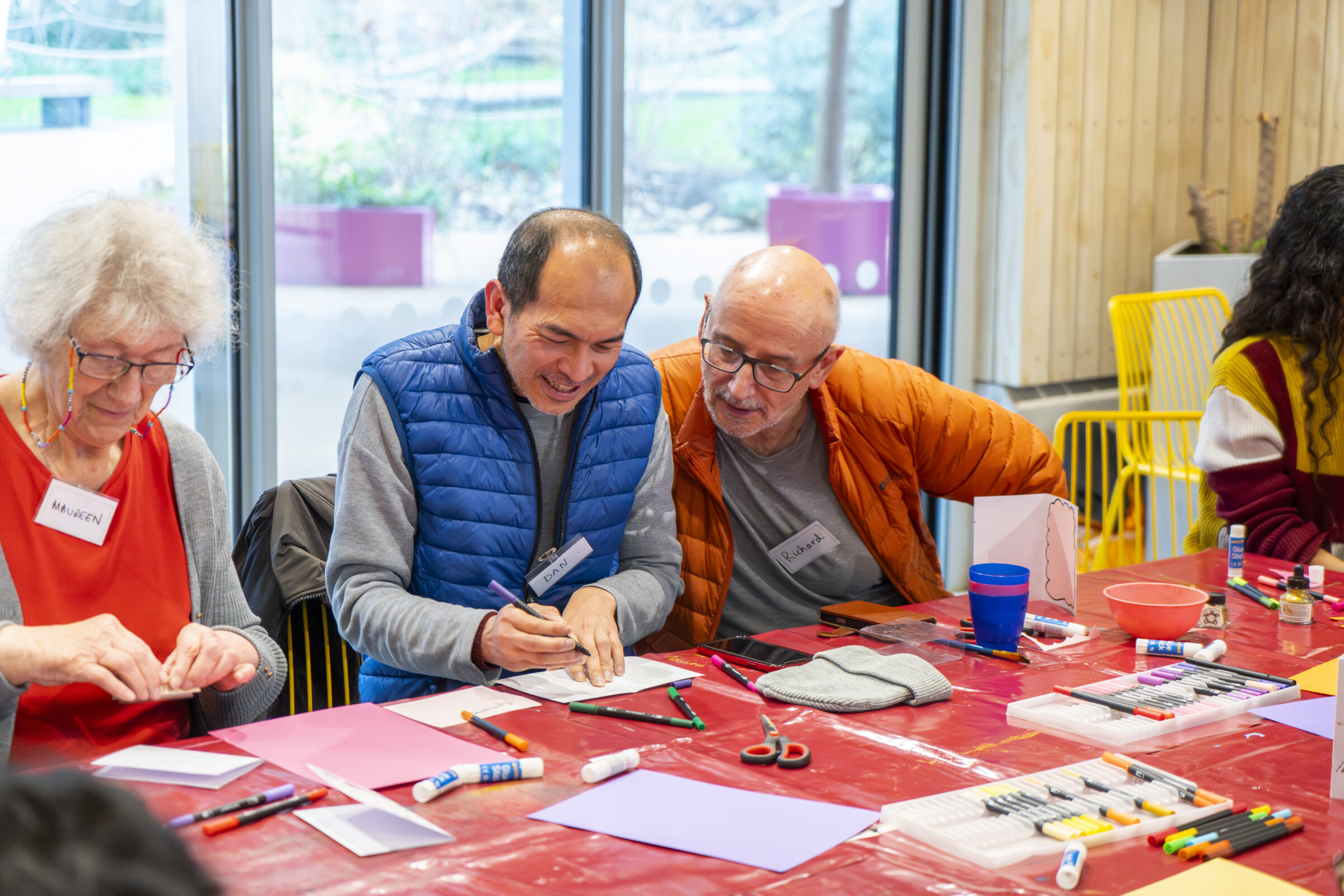 Two participants making card photo frames at the Box Camera workshop